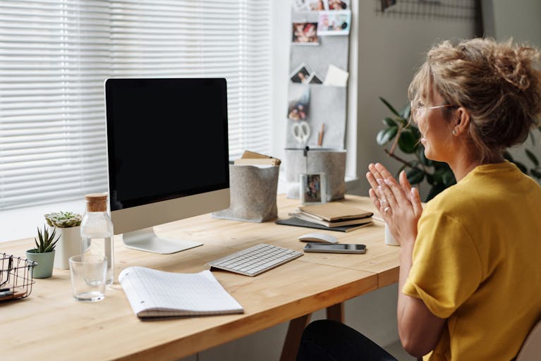 Woman in Yellow Shirt Sitting In Front Of A Computer