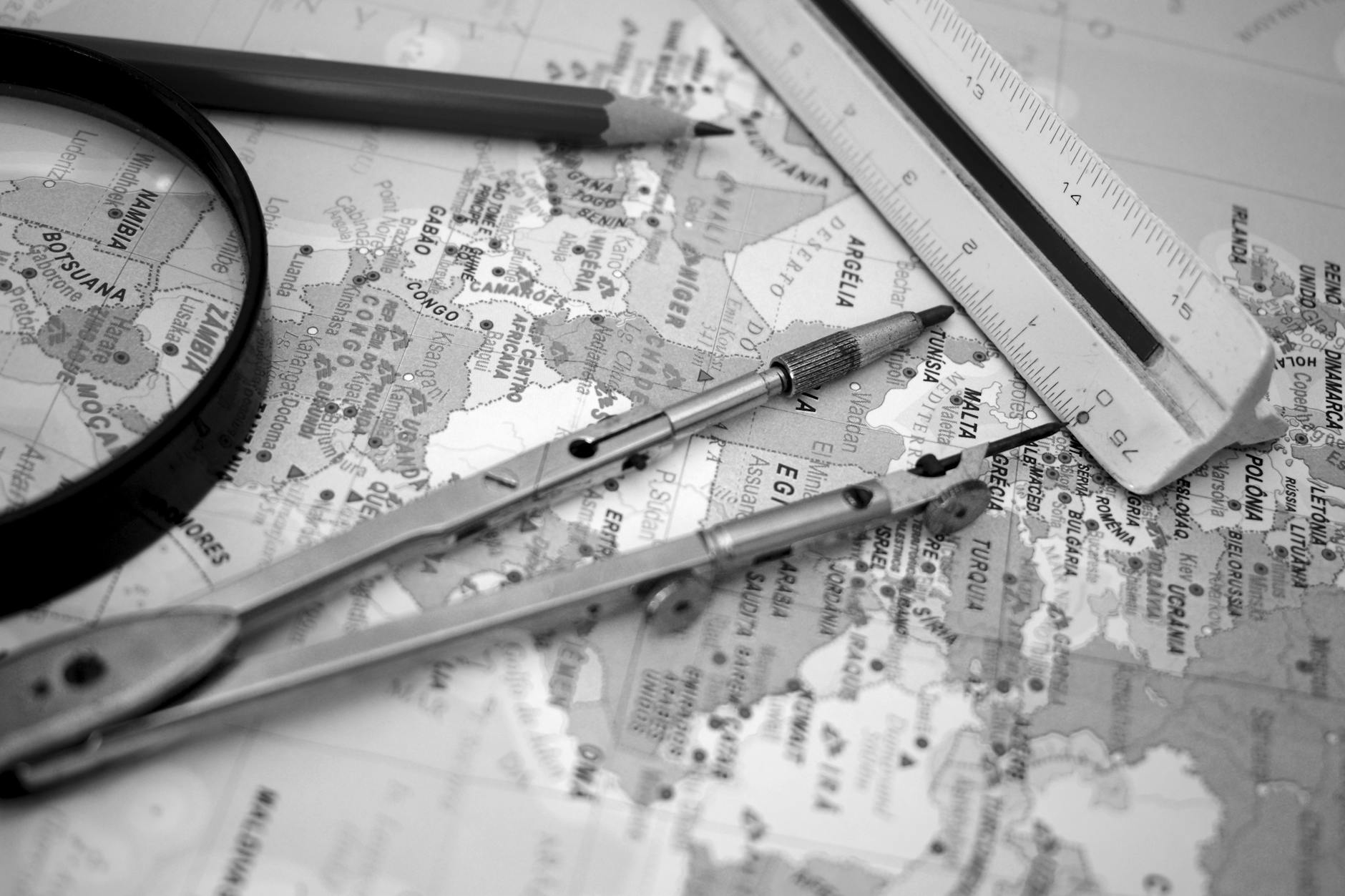 ruler pen and compass on map