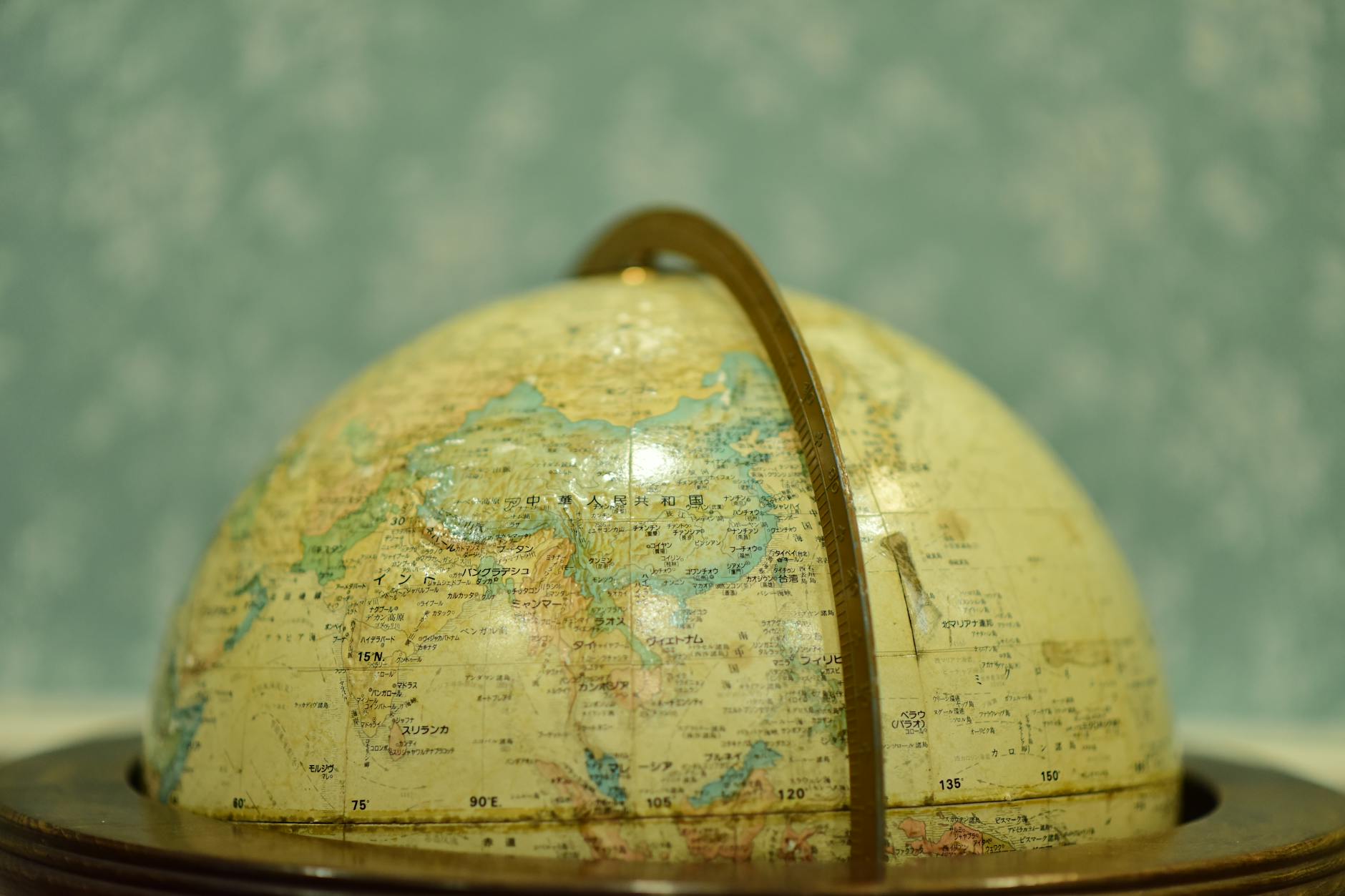 vintage globe on wooden stand in soft focus