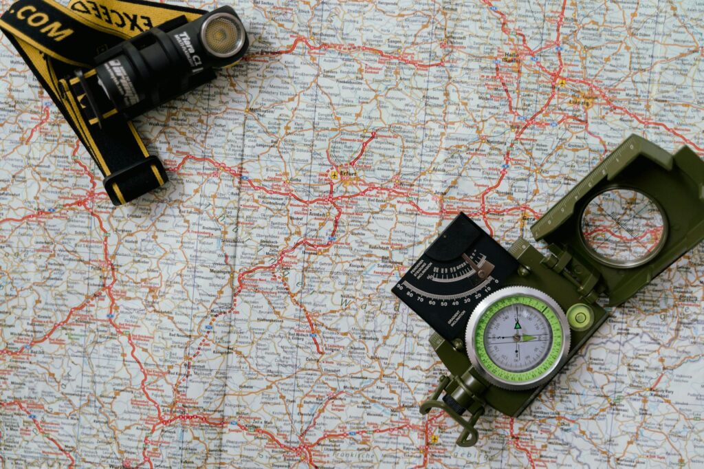 a compass and flashlight on a map